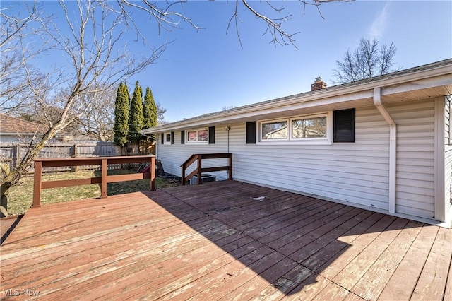 wooden terrace featuring fence