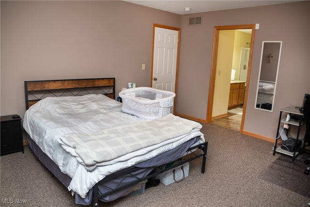 bedroom featuring visible vents, light colored carpet, and baseboards