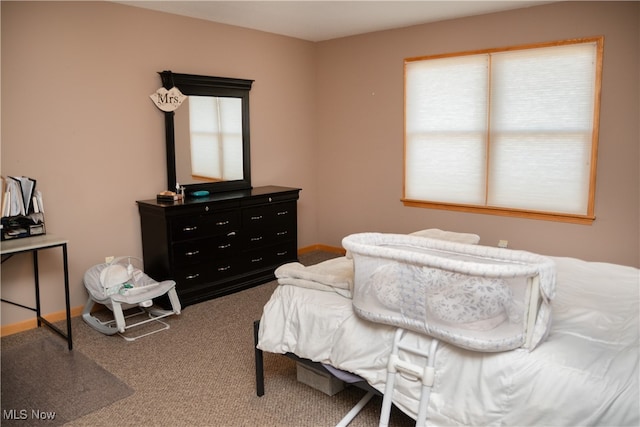 bedroom with baseboards and carpet