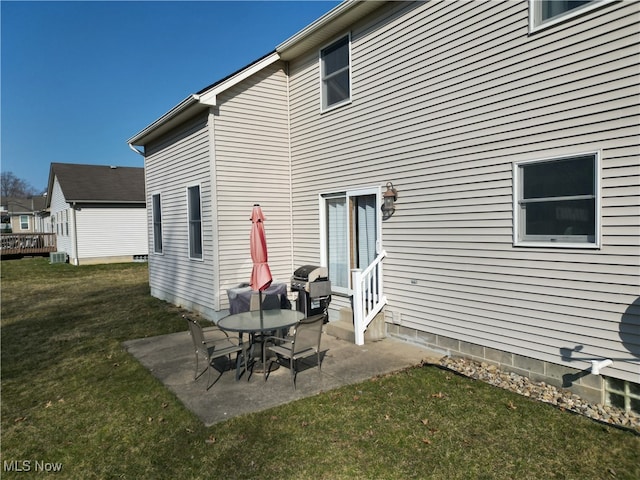 rear view of house with a yard, a patio, central air condition unit, and entry steps