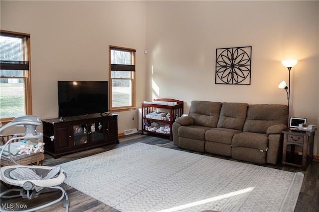 living area featuring baseboards and wood finished floors