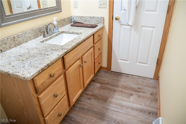 bathroom with vanity and wood finished floors