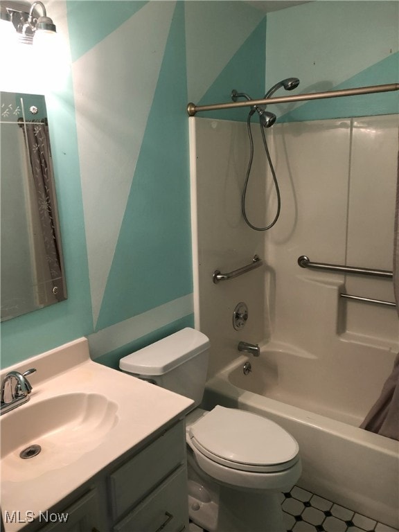 full bathroom with vanity, shower / tub combo, and toilet