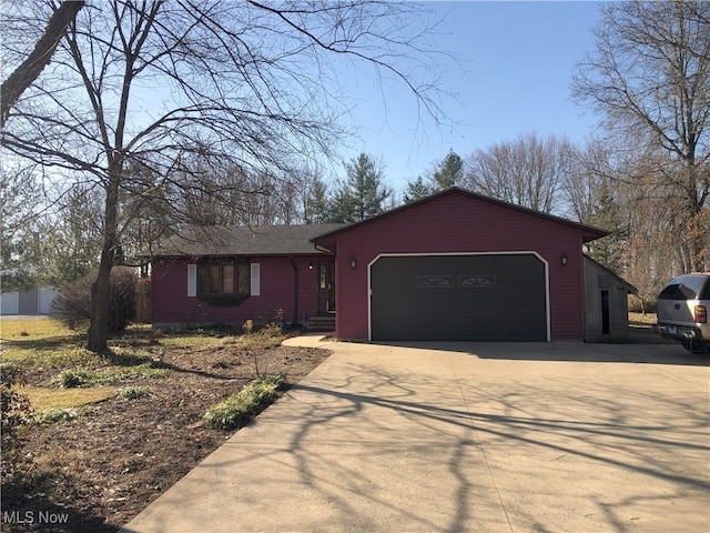 ranch-style house featuring driveway and a garage