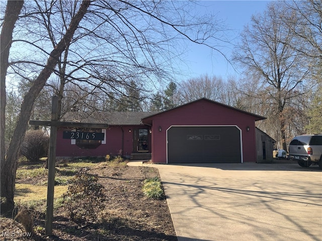 ranch-style home with an attached garage and driveway