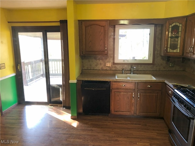 kitchen featuring a sink, range with gas cooktop, black dishwasher, and a healthy amount of sunlight