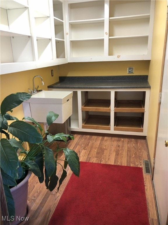 interior space with visible vents, light wood-style floors, and a sink