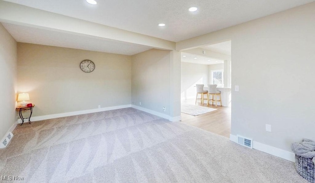 spare room featuring recessed lighting, visible vents, baseboards, and carpet