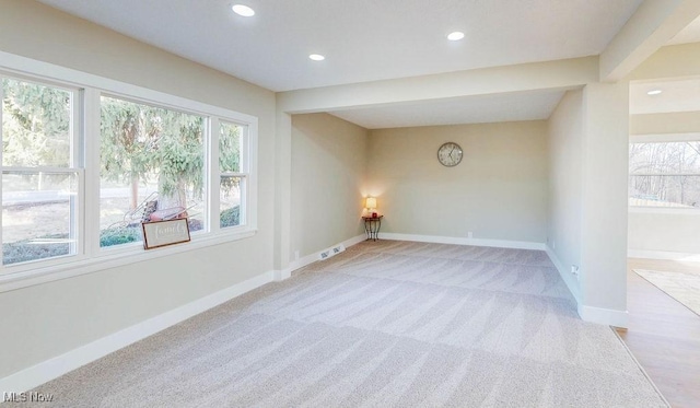 spare room featuring recessed lighting, baseboards, and light carpet