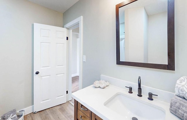 bathroom with wood finished floors and vanity