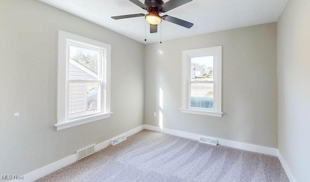 empty room featuring visible vents and baseboards