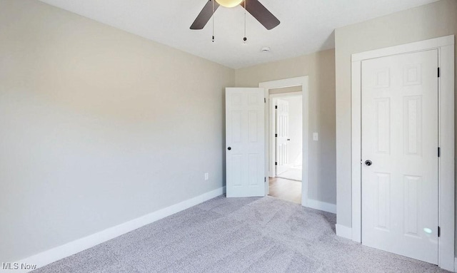 unfurnished bedroom with carpet flooring, ceiling fan, and baseboards