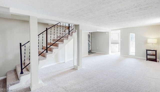 basement with stairs, carpet, baseboards, and a textured ceiling