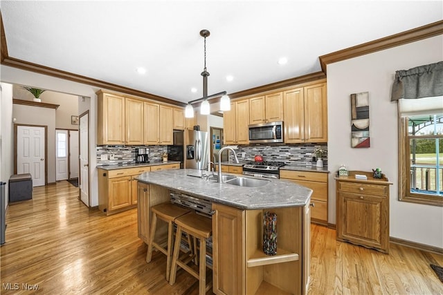 kitchen with open shelves, an island with sink, a sink, appliances with stainless steel finishes, and light wood-type flooring