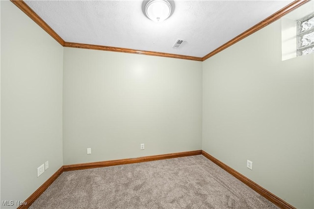 unfurnished room with baseboards, ornamental molding, and carpet flooring