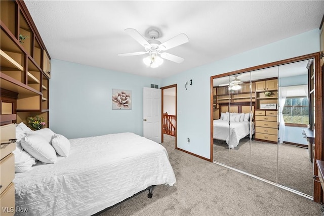 unfurnished bedroom with visible vents, a ceiling fan, a closet, carpet floors, and baseboards