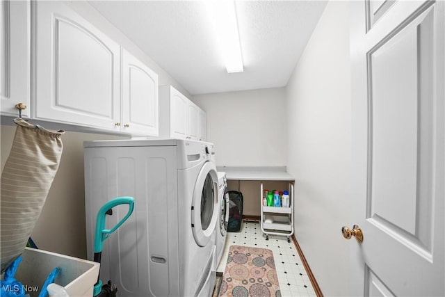 washroom with cabinet space, independent washer and dryer, and light floors