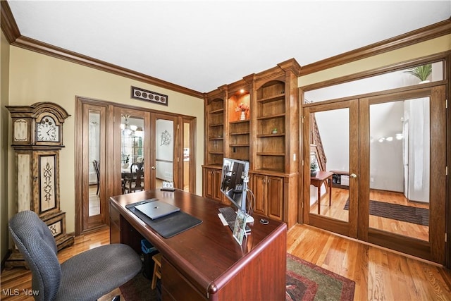 home office with light wood-style flooring, french doors, and ornamental molding