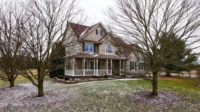 view of front of home with a porch and a front yard