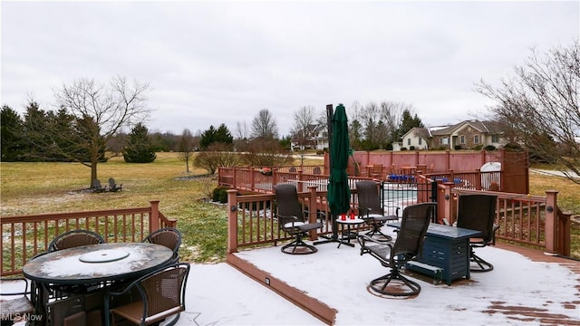 deck with a yard and outdoor dining space