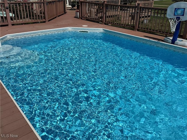 view of swimming pool featuring a deck