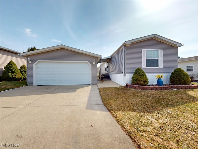 view of front of house with entry steps, a front yard, concrete driveway, and a garage