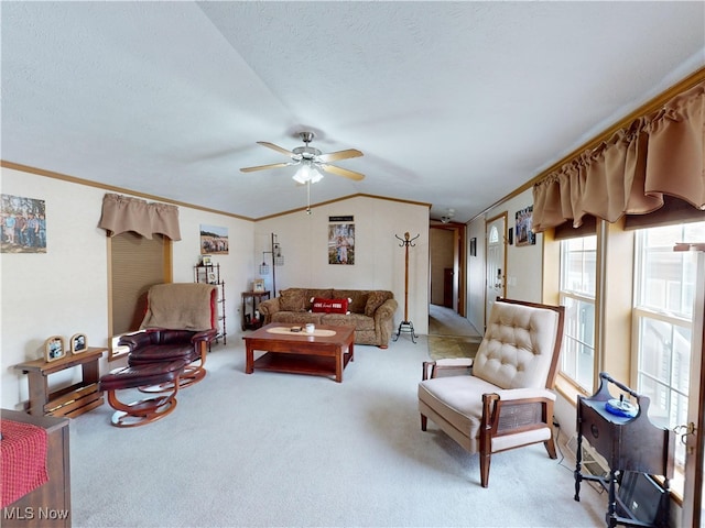 living area with lofted ceiling, crown molding, light colored carpet, and ceiling fan