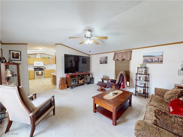 living area featuring crown molding, a ceiling fan, and vaulted ceiling