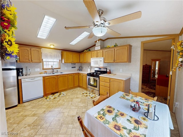 kitchen with a sink, appliances with stainless steel finishes, ceiling fan, and light countertops