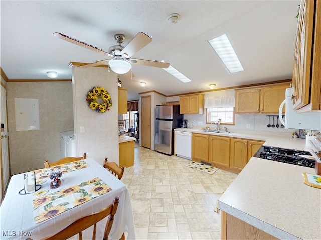 kitchen with a sink, freestanding refrigerator, gas stove, dishwasher, and ceiling fan