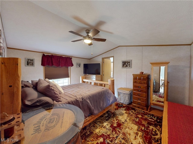 bedroom with ceiling fan, crown molding, and lofted ceiling