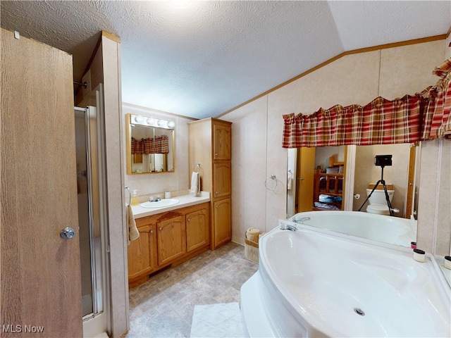 full bathroom featuring vanity, lofted ceiling, a stall shower, tile patterned floors, and a textured ceiling