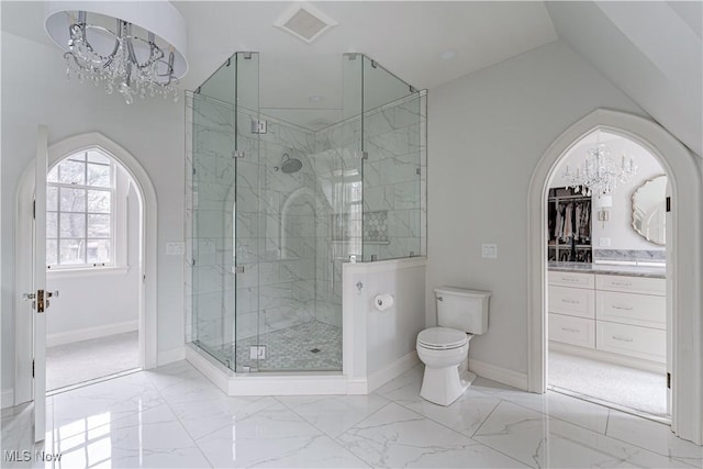 bathroom featuring visible vents, toilet, marble finish floor, a stall shower, and an inviting chandelier