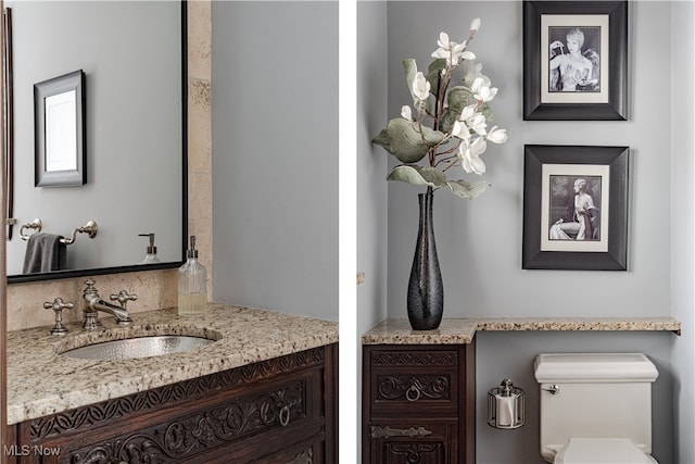 bathroom featuring toilet and vanity