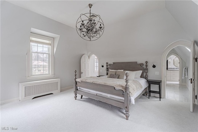 bedroom with radiator heating unit, arched walkways, baseboards, light colored carpet, and a chandelier