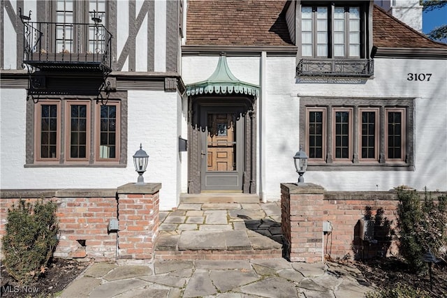 property entrance with brick siding