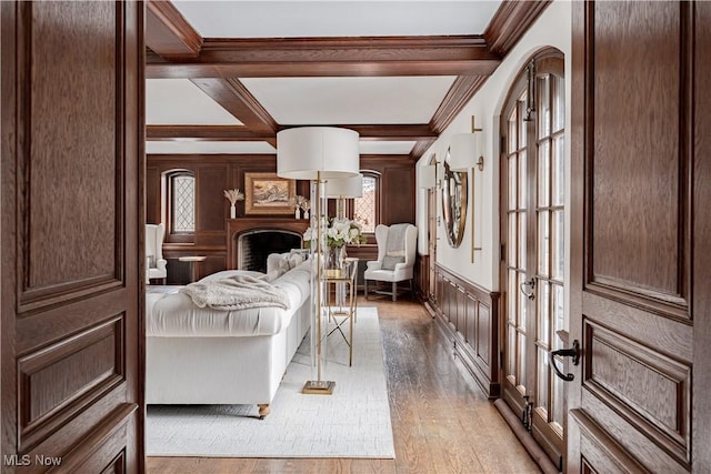 foyer featuring light wood-type flooring, french doors, plenty of natural light, and crown molding