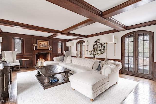 living room with hardwood / wood-style flooring, beamed ceiling, french doors, and coffered ceiling