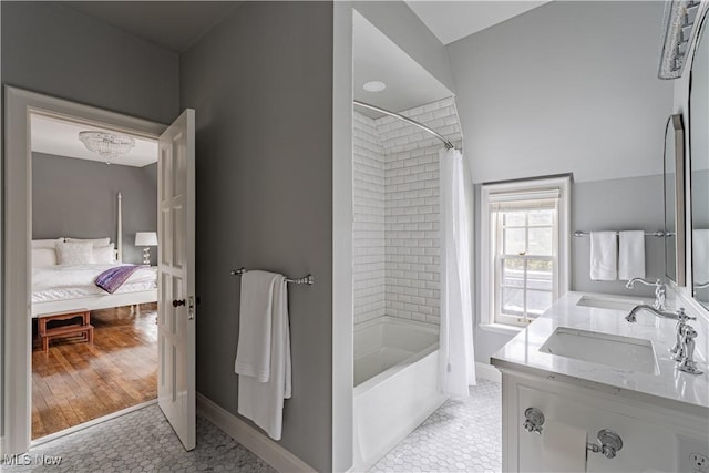 full bathroom with a sink, shower / tub combo with curtain, and tile patterned flooring