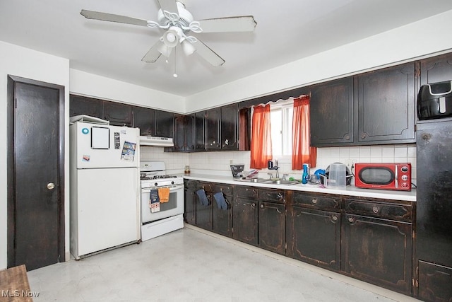 kitchen with under cabinet range hood, white appliances, a ceiling fan, and light countertops