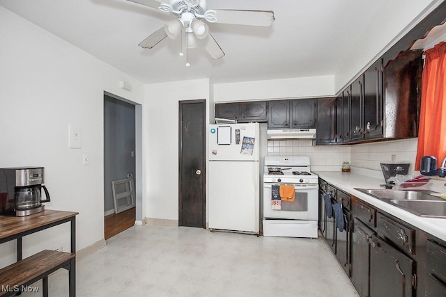 kitchen with white appliances, ceiling fan, light countertops, under cabinet range hood, and tasteful backsplash