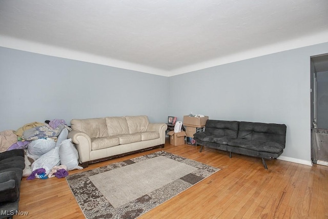 living room with baseboards and hardwood / wood-style floors