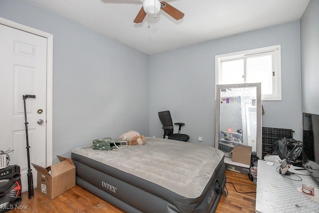 bedroom with wood finished floors and ceiling fan