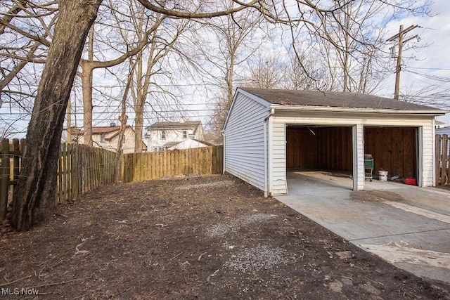 detached garage featuring fence