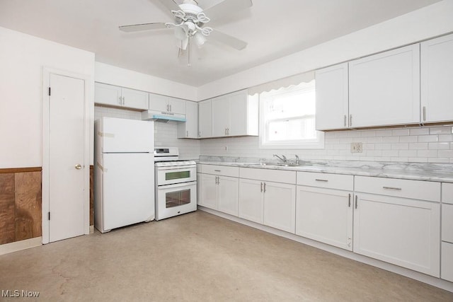 kitchen featuring under cabinet range hood, light countertops, decorative backsplash, white appliances, and a sink