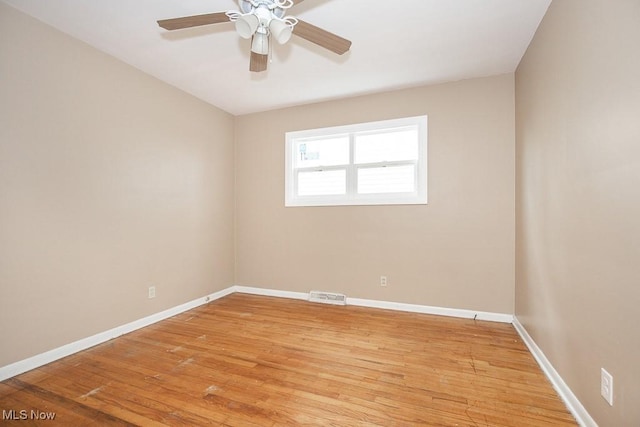 unfurnished room with a ceiling fan, baseboards, visible vents, and light wood finished floors