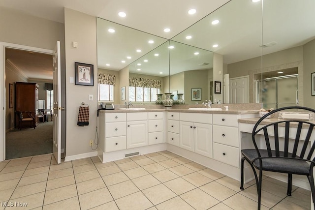 bathroom featuring a sink, recessed lighting, a shower stall, tile patterned flooring, and double vanity