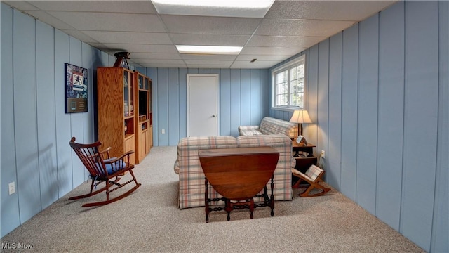 interior space with a paneled ceiling and carpet floors