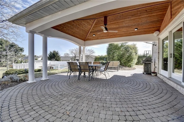 view of patio / terrace featuring area for grilling, a ceiling fan, fence, a gazebo, and outdoor dining area