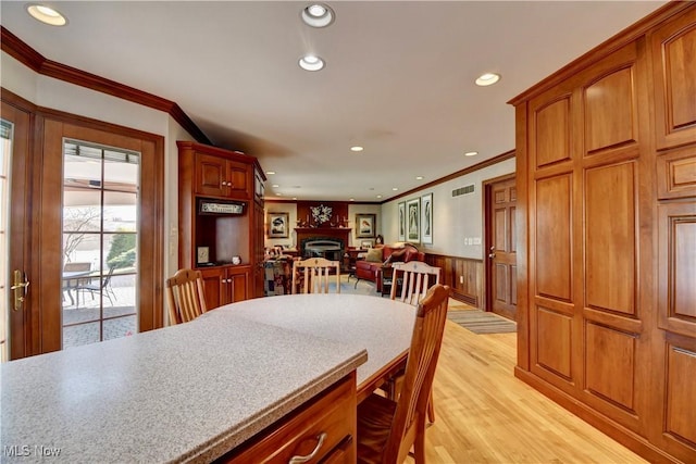 dining room with ornamental molding, recessed lighting, visible vents, and wainscoting